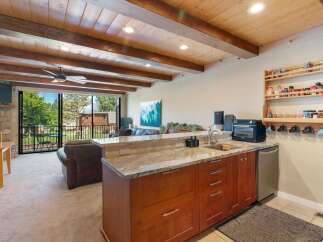 Experience comfortable living in this inviting space featuring a well-equipped kitchenette with ample cabinet storage and a granite countertop.