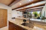 Experience rustic charm and modern comfort in this stunning property featuring a vaulted wood-beamed ceiling and a cozy stone fireplace.