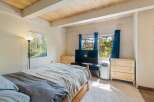 This inviting bedroom features a comfortable bed adorned with cozy linens, perfect for a restful night's sleep.