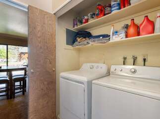 Discover convenience with this in-unit laundry space, featuring a stacked washer and dryer.