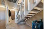 Step into this welcoming entryway featuring a convenient coat rack and a sturdy wooden front door.