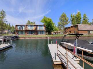 Enjoy waterfront living with this stunning property featuring private docks and boat slips, perfect for water enthusiasts.
