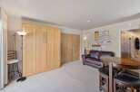 This versatile room features a space-saving Murphy bed, perfect for maximizing living area.
