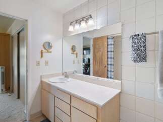 This bathroom features a spacious vanity with ample storage and a clean white countertop.