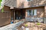Discover this charming property featuring a warm brown exterior with natural wood siding and decorative stone accents.