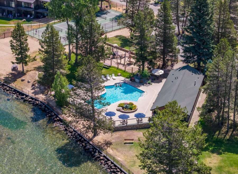 Experience lakeside living with this stunning aerial view of a resort-style property.
