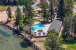 Experience lakeside living with this stunning aerial view of a resort-style property.