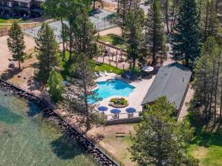 Experience lakeside living with this stunning aerial view of a resort-style property.
