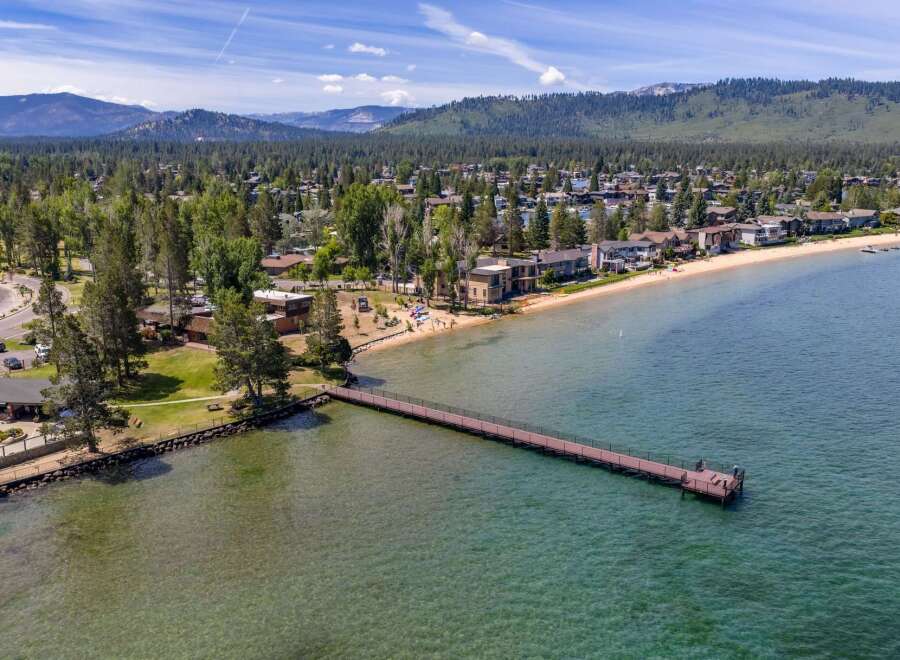 Experience luxury lakeside living with this stunning property featuring direct beach access and a private pier.