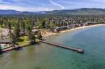 Experience luxury lakeside living with this stunning property featuring direct beach access and a private pier.