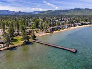 Experience luxury lakeside living with this stunning property featuring direct beach access and a private pier.