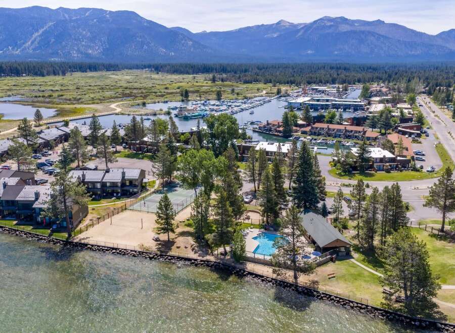 Experience lakeside living at its finest with this stunning aerial view of a resort-style property.