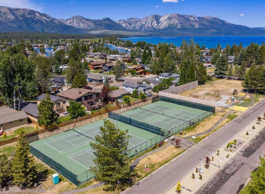 Experience luxury living with this stunning aerial view showcasing pristine tennis courts, perfect for active lifestyles.