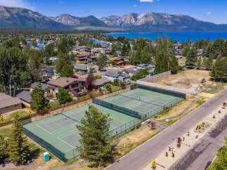 Experience luxury living with this stunning aerial view showcasing pristine tennis courts, perfect for active lifestyles.