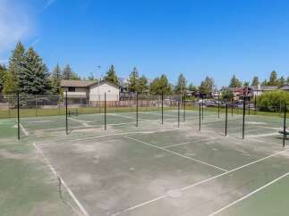 Enjoy an active lifestyle with this property's multiple tennis courts, perfect for friendly matches or serious training.