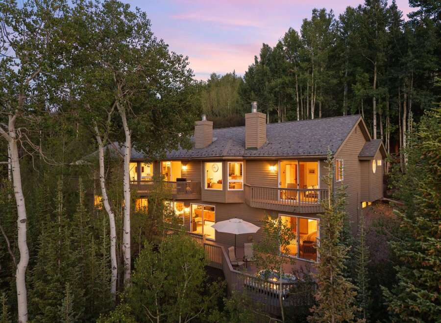 Nestled amidst a serene forest, this multi-level home offers a luxurious mountain retreat.