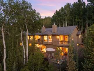 Nestled amidst a serene forest, this multi-level home offers a luxurious mountain retreat.