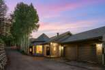 Nestled amidst a serene forest setting, this unique stone home offers a captivating blend of rustic charm and modern comfort.