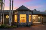 Experience the charm of this unique home featuring a striking stone facade and a distinctive octagonal turret with large windows.