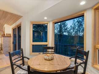 Enjoy breathtaking mountain views from this charming dining area, perfect for intimate meals or lively gatherings.