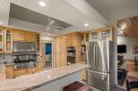 Experience culinary excellence in this stunning kitchen, featuring sleek stainless steel appliances, a professional-grade gas range, and ample custom cabinetry.