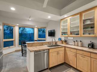 Experience breathtaking mountain views from this stunning kitchen, featuring a large bay window that floods the space with natural light.
