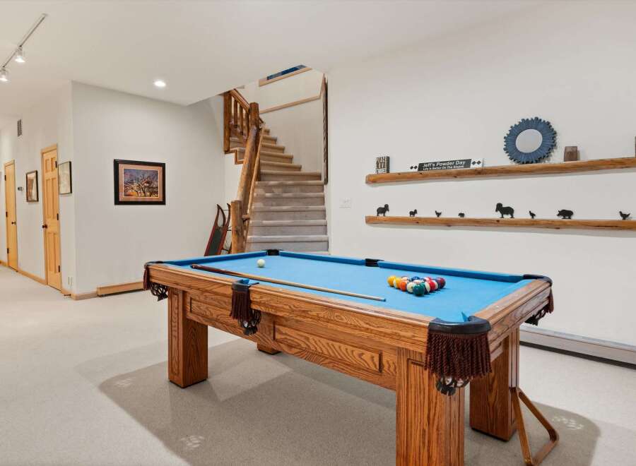 Enjoy endless entertainment in this finished basement, featuring a full-size pool table perfect for game nights.