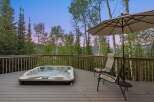 Experience ultimate relaxation on this spacious deck, featuring a luxurious hot tub perfect for soaking in the stunning mountain views.