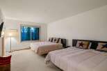 This spacious bedroom features two queen-sized beds, perfect for accommodating family or guests.