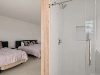 This inviting bedroom features two comfortable beds, perfect for accommodating guests or family.