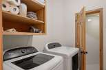 This laundry room features a Whirlpool Cabrio top-load washer and a matching dryer, perfect for handling family-sized loads.