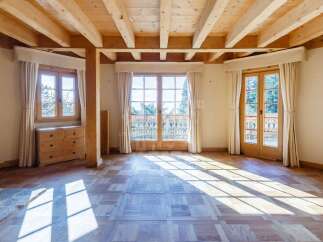 Experience rustic charm in this beautifully appointed room featuring exposed wooden beams and a warm, natural wood finish throughout.