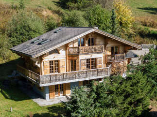 Experience the charm of this stunning wooden chalet nestled amidst lush greenery and rolling hills.