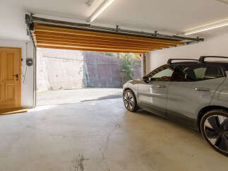 This spacious garage features an automatic wooden garage door opening to a concrete driveway.