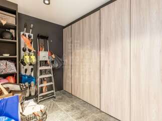 Discover ample storage solutions in this home, featuring a tall shelving unit perfect for organizing sports equipment and accessories.