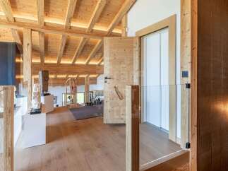 Experience rustic luxury in this stunning mountain home, featuring exposed wooden beams and a warm, inviting ambiance.