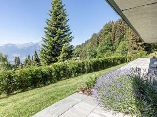 Experience breathtaking mountain views from this modern home, featuring a spacious patio perfect for outdoor living.