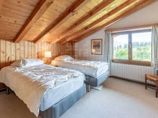 This charming attic bedroom features two comfortable twin beds, perfect for guests or a family.