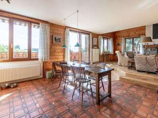 Experience rustic charm in this inviting dining area, featuring a sturdy wooden table and chairs perfect for family gatherings.