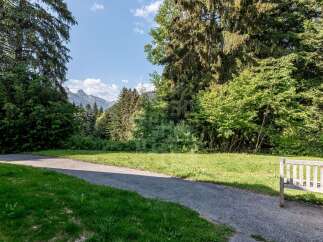 Enjoy the serene beauty of this property, nestled amidst lush greenery and mature trees.
