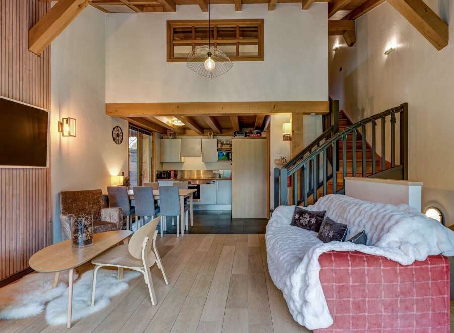 Experience the charm of this mountain retreat, featuring a spacious open-plan living area with a modern kitchen and dining space.