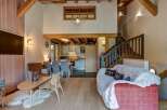 Experience the charm of this mountain retreat, featuring a spacious open-plan living area with a modern kitchen and dining space.