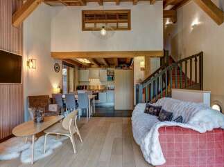 Experience the charm of this mountain retreat, featuring a spacious open-plan living area with a modern kitchen and dining space.