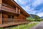 Experience alpine charm in this stunning wooden chalet, featuring a spacious balcony perfect for enjoying mountain views.