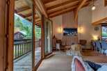 Experience mountain living in this stunning chalet, featuring a spacious open-plan living area with a cozy fireplace and breathtaking views.
