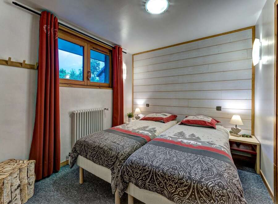 This charming bedroom features two comfortable twin beds, perfect for accommodating guests or family.