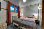 This charming bedroom features two comfortable twin beds, perfect for accommodating guests or family.