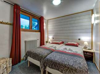 This charming bedroom features two comfortable twin beds, perfect for accommodating guests or family.