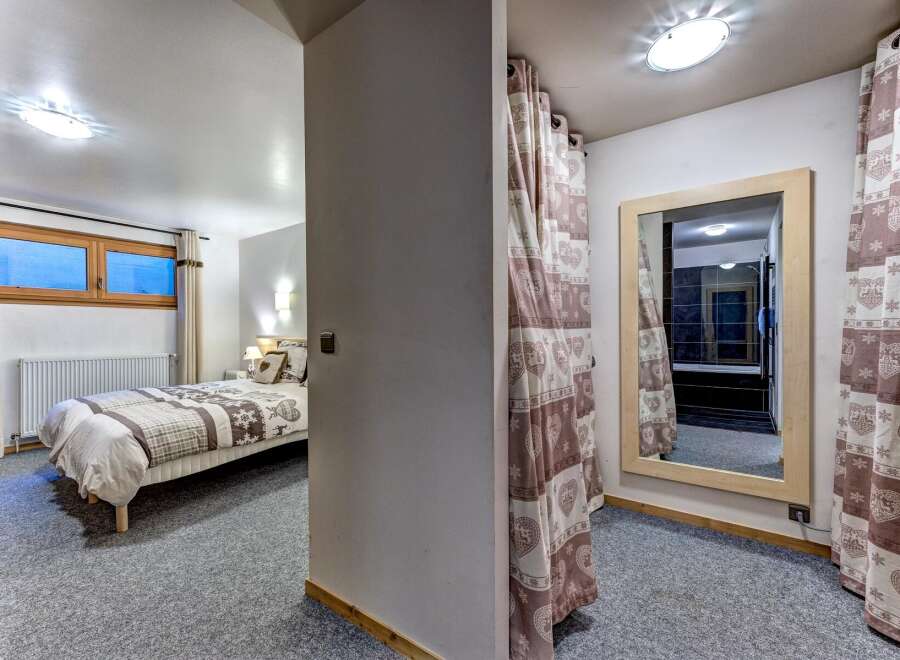 This charming bedroom features a comfortable bed with cozy linens, perfect for a restful night's sleep.