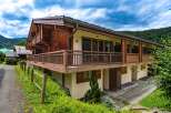 Experience alpine living in this charming wooden chalet, featuring a spacious balcony perfect for enjoying mountain views.